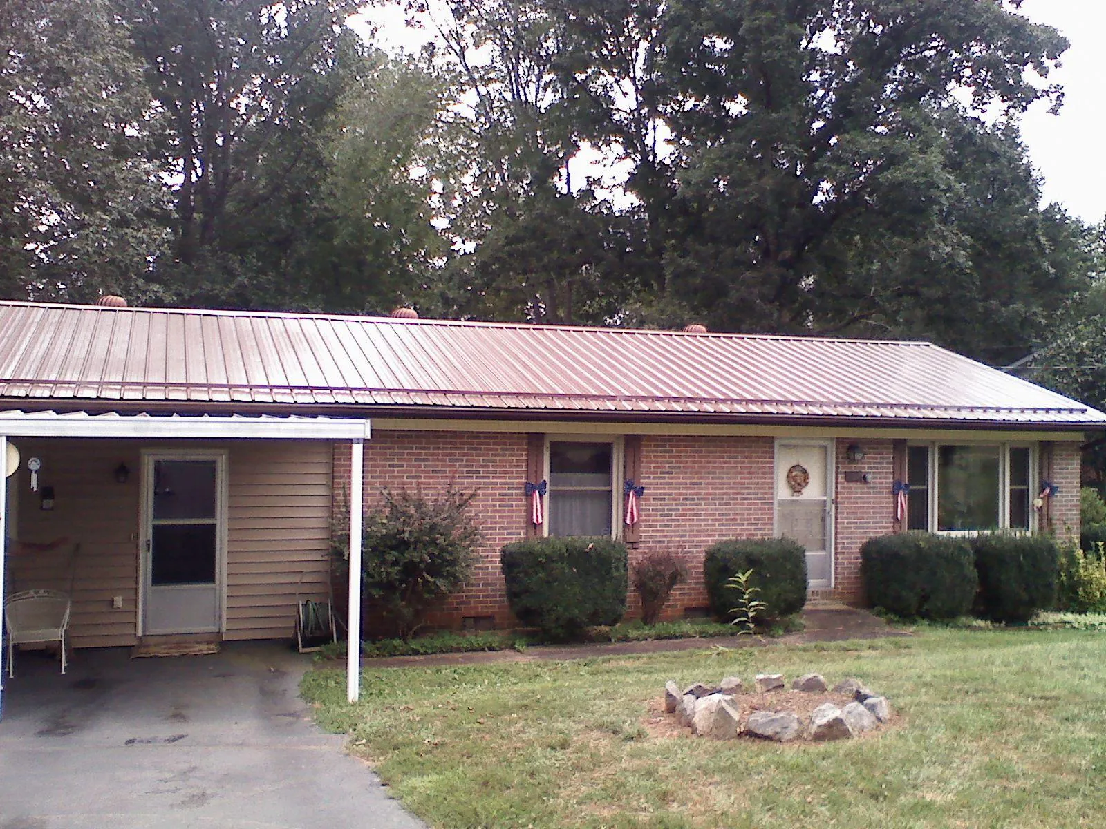 Bronze metal roof and carport on a brick ranch home — Roof Repair work by our crew in Newtown Square